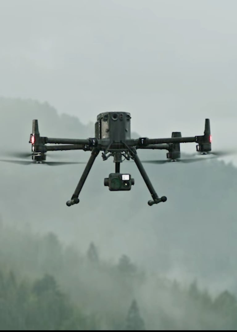 a small drone flying over a mountain range