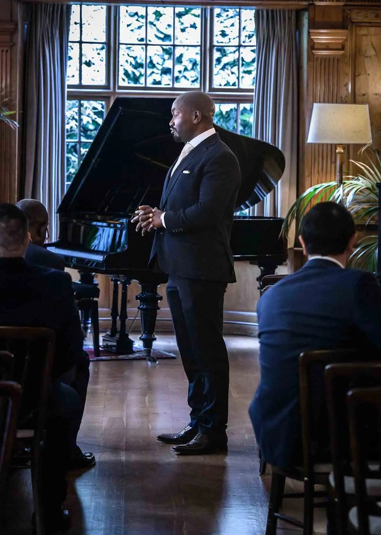groom standing in front of a grand piano waiting for his bride