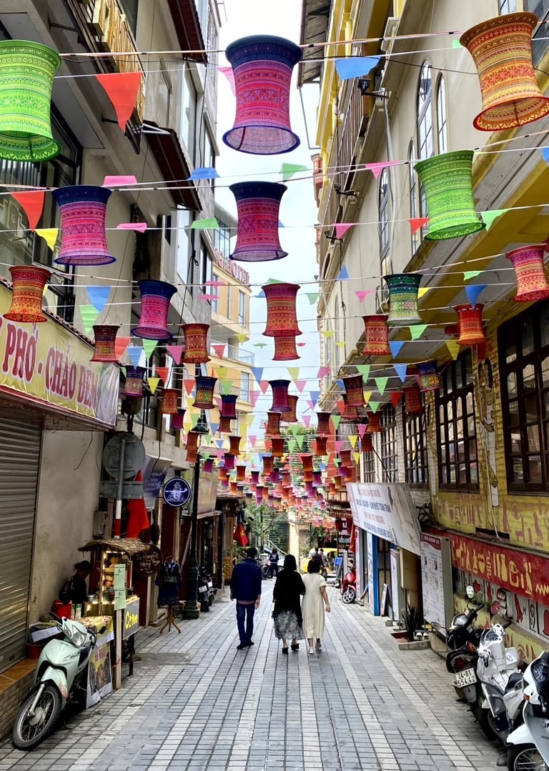 a couple of people walking down a street
