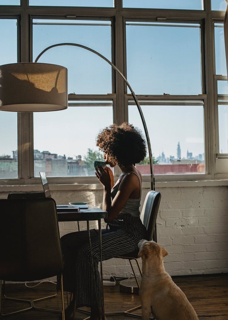 a woman sitting at a table with a dog