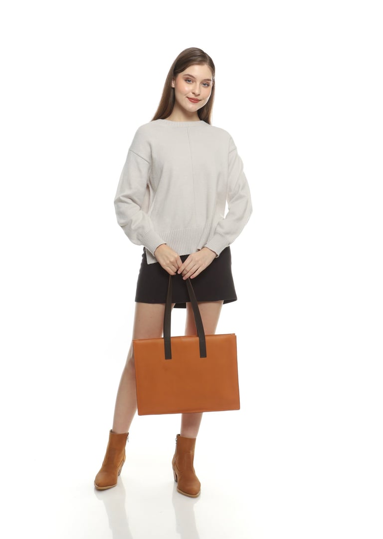 a woman in brown boots and brown totebag