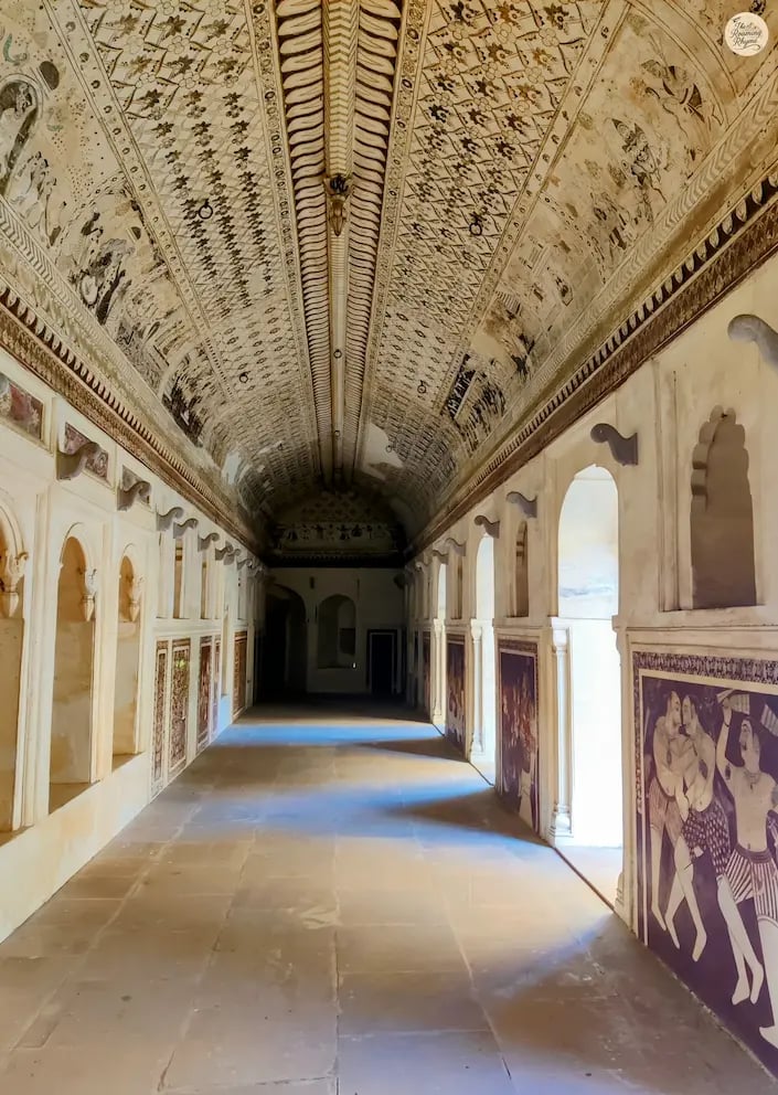 ainted gallery of Lakshmi Temple, Orchha, featuring mythological frescoes and Bundela artistry.