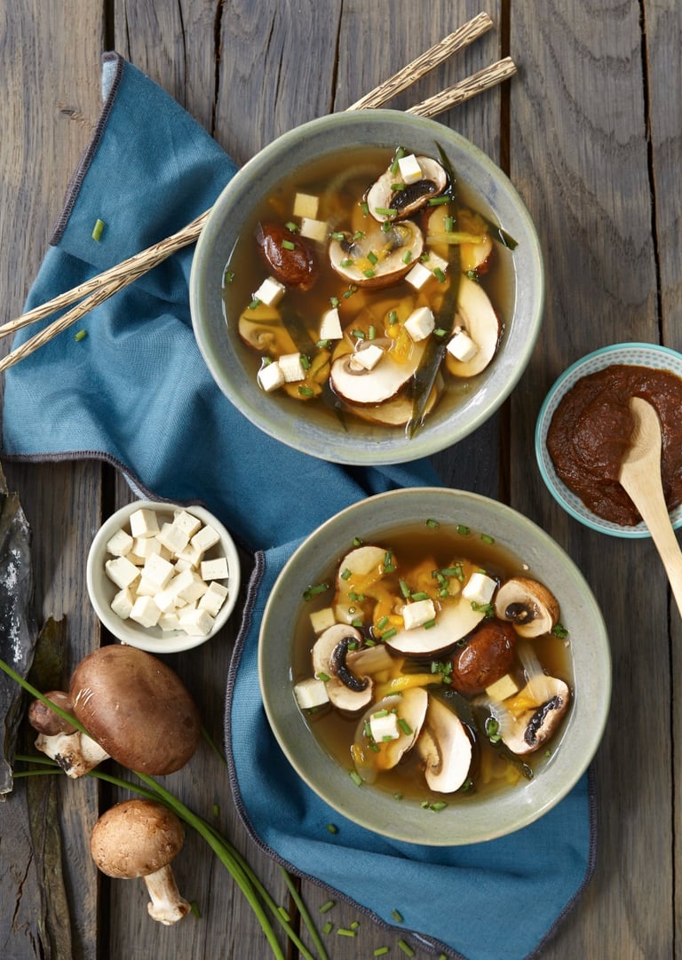 a couple of bowls of soup with mushrooms and mushrooms