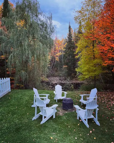 a fire pit with chairs and a fire pit