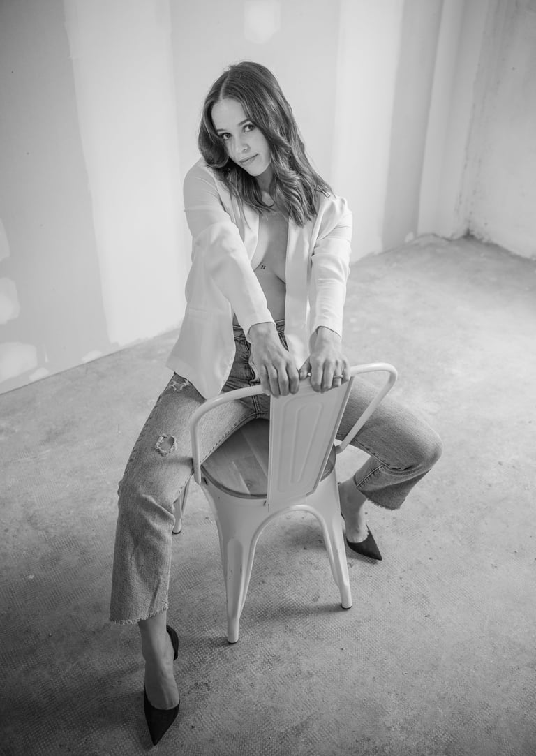 a woman sitting on a chair in a room during a shooting photo 