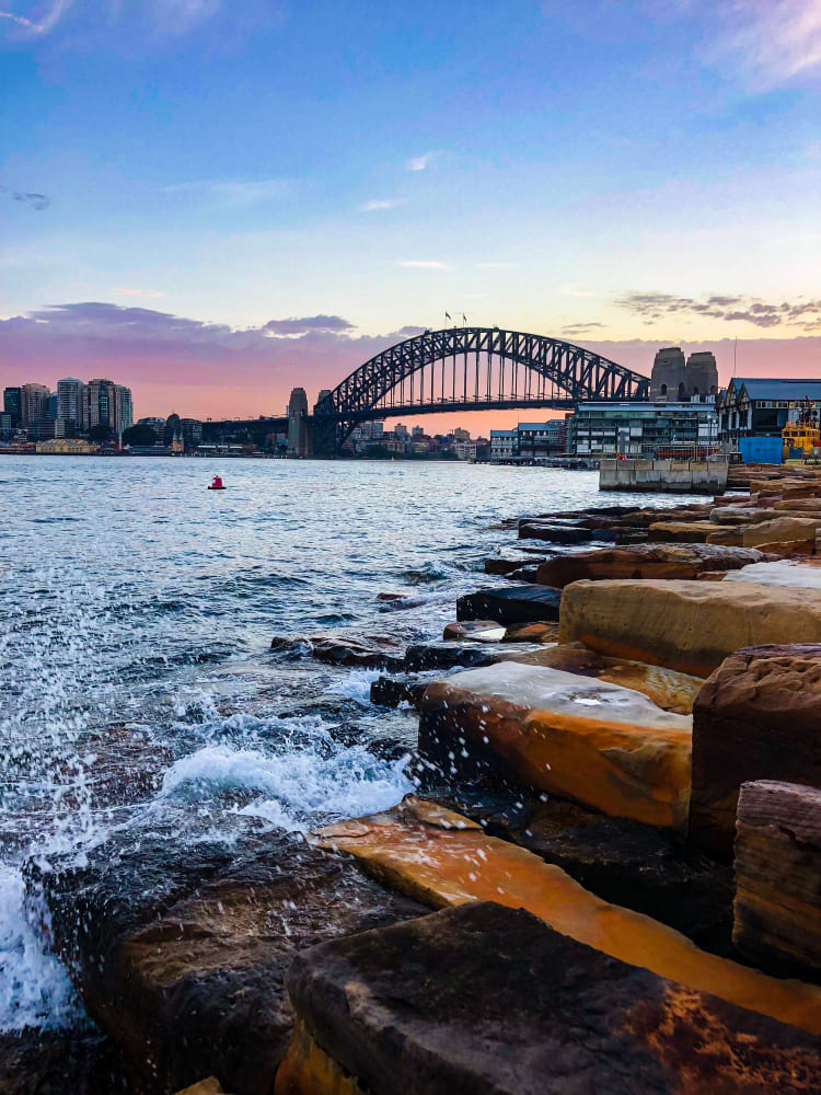 Sydney Harbour Bridge over water with the bridge in the background