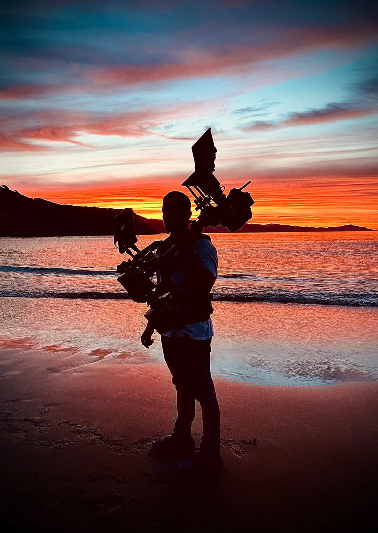 Steadicam operator silhouette at sunshine on the beach