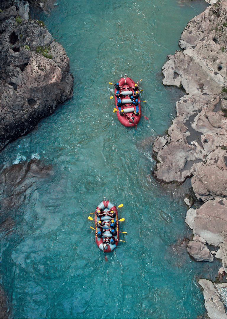 a group of people rafting down a river