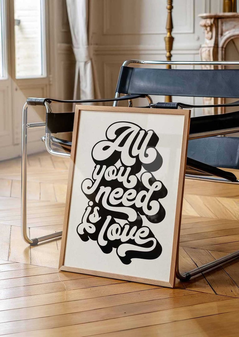 Retro black and white typography wall art featuring the quote All You Need Is Love