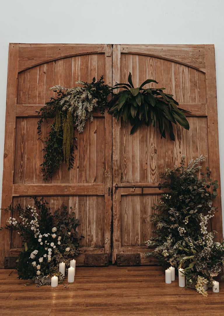  Wedding flower backdrop of foliage on a wooden barn door at Talhenbont Hall