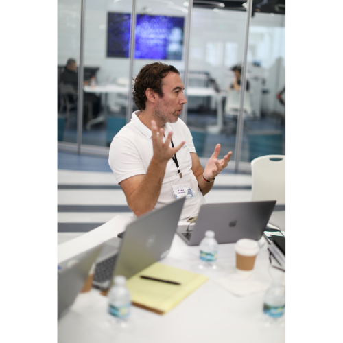 a man in a white shirt and a laptop computer AI training
