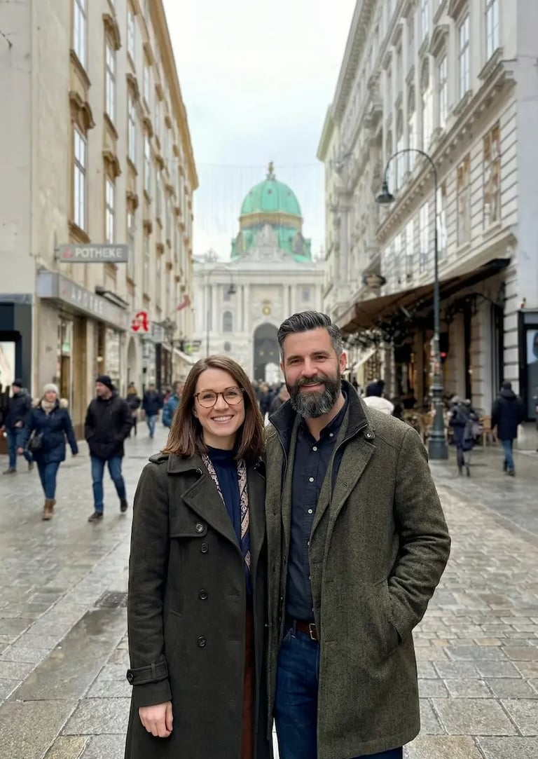 Couple exploring Vienna city center with St. Michael’s Church in the background.