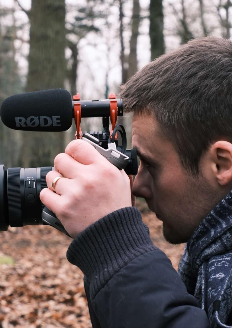 a man is taking a photo of a camera and recording a video camera