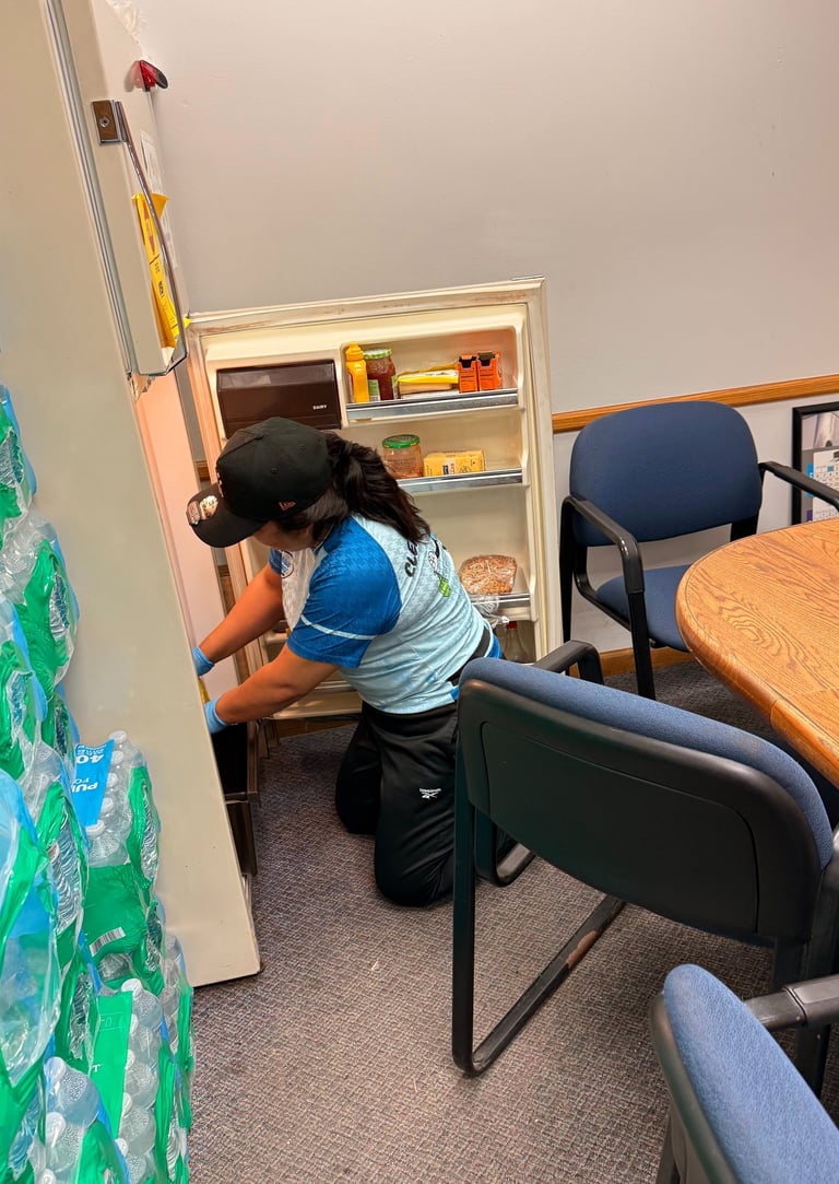 Commercial cleaning staff sanitizing office workspace