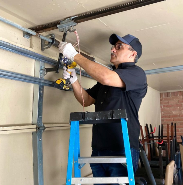 a man in a blue shirt is holding a tool and a tool