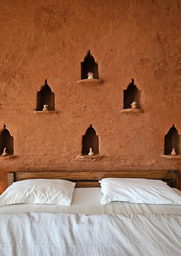 Rustic mudstone wall room with sit-out deck in Ilika Resorts
