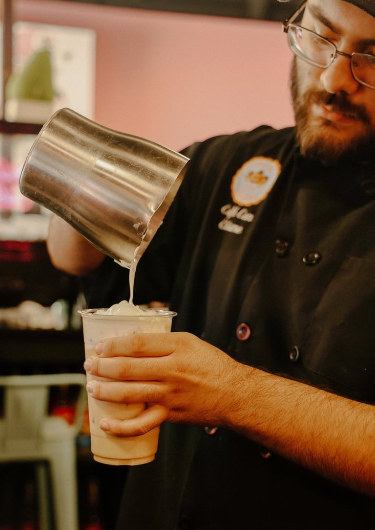 cafe con chisme barista making a latte