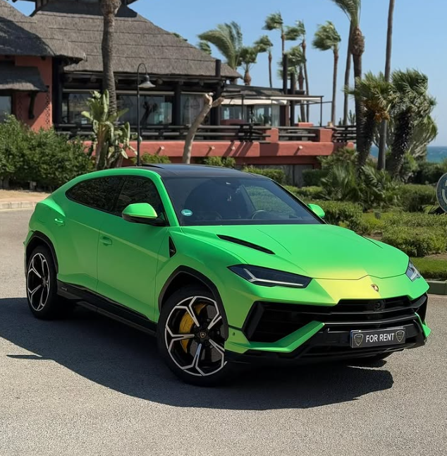 Luxury neon green Lamborghini Urus SUV parked at a tropical resort for rent.