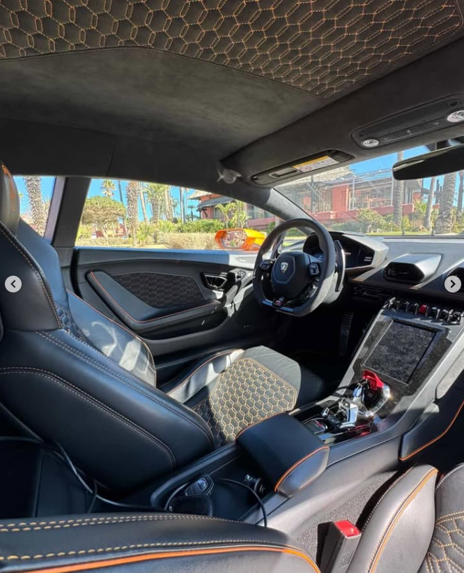 Luxury Lamborghini interior featuring black leather seats with orange honeycomb stitching and Alcantara trim.