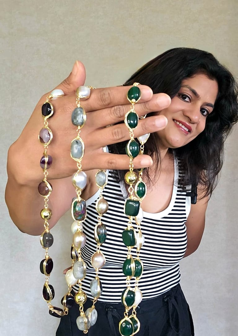 Woman showcasing vibrant global-inspired gemstone necklaces from Iridezza’s Global Glam jewelry coll