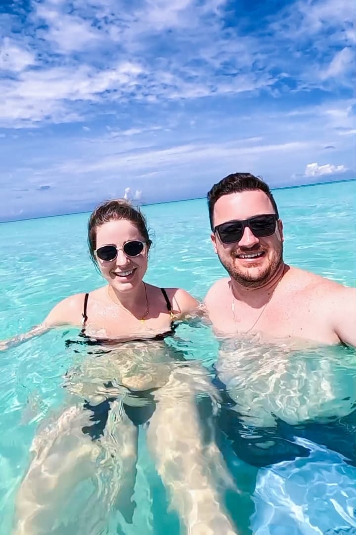 a man and woman in bikinis in the ocean