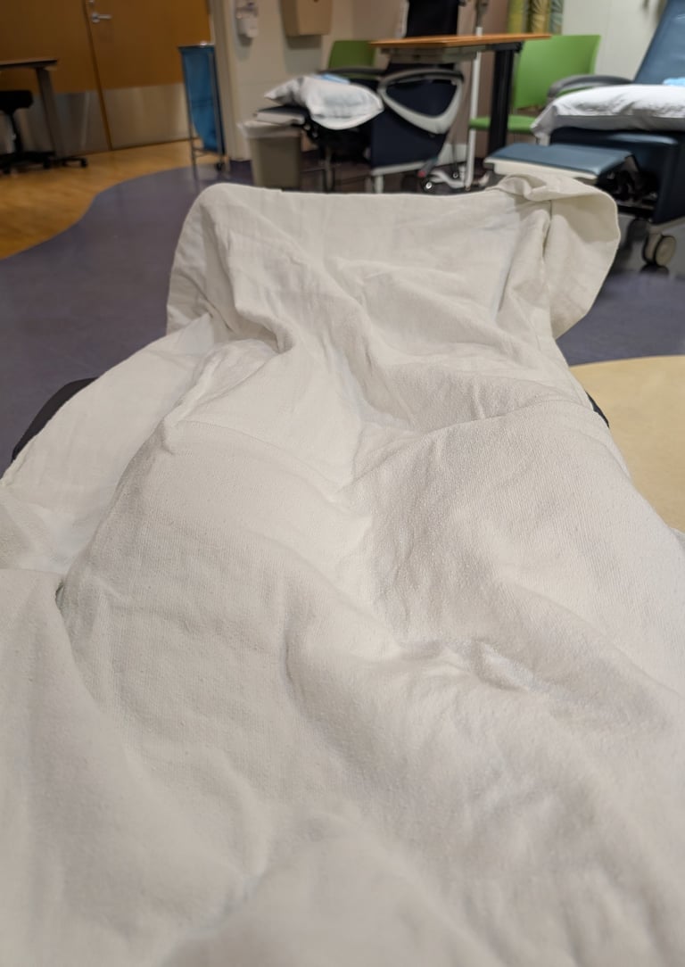 Greg Rowland at Duke Health covered with a warm blanket