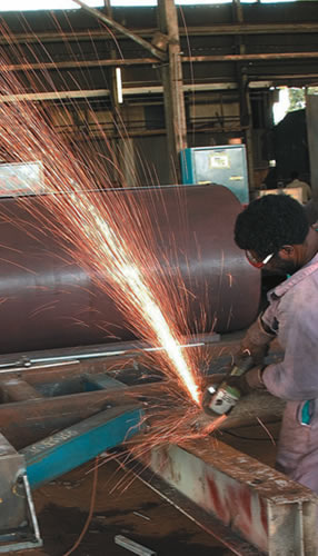 a man with fettling operation in a kiln burner