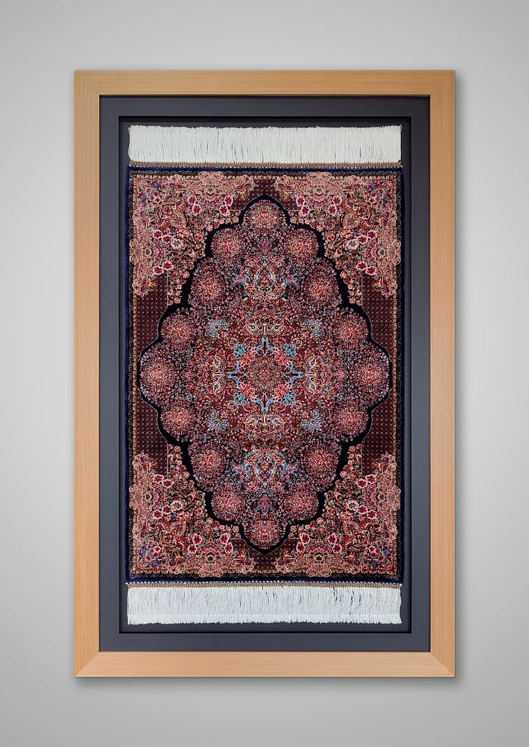 An oriental carpet framed in a natural wooden frame and set against a black border and backing.