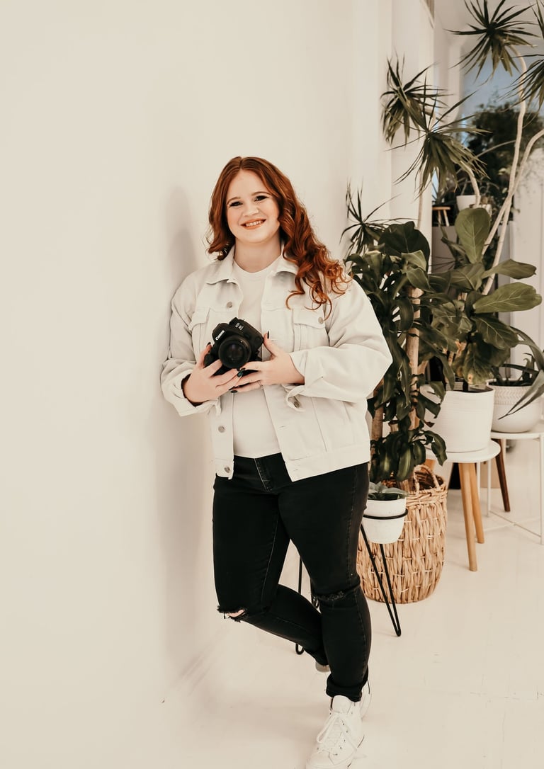 Rachel smiling and holding her camera
