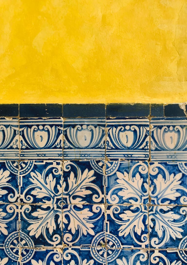 a blue and white tile wall with a yellow wall