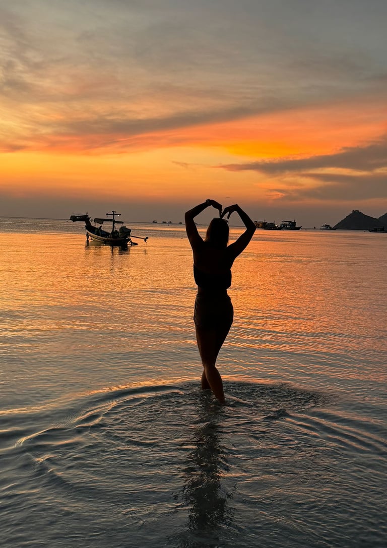 woman in the beach silhouette beautiful sunset  in the background