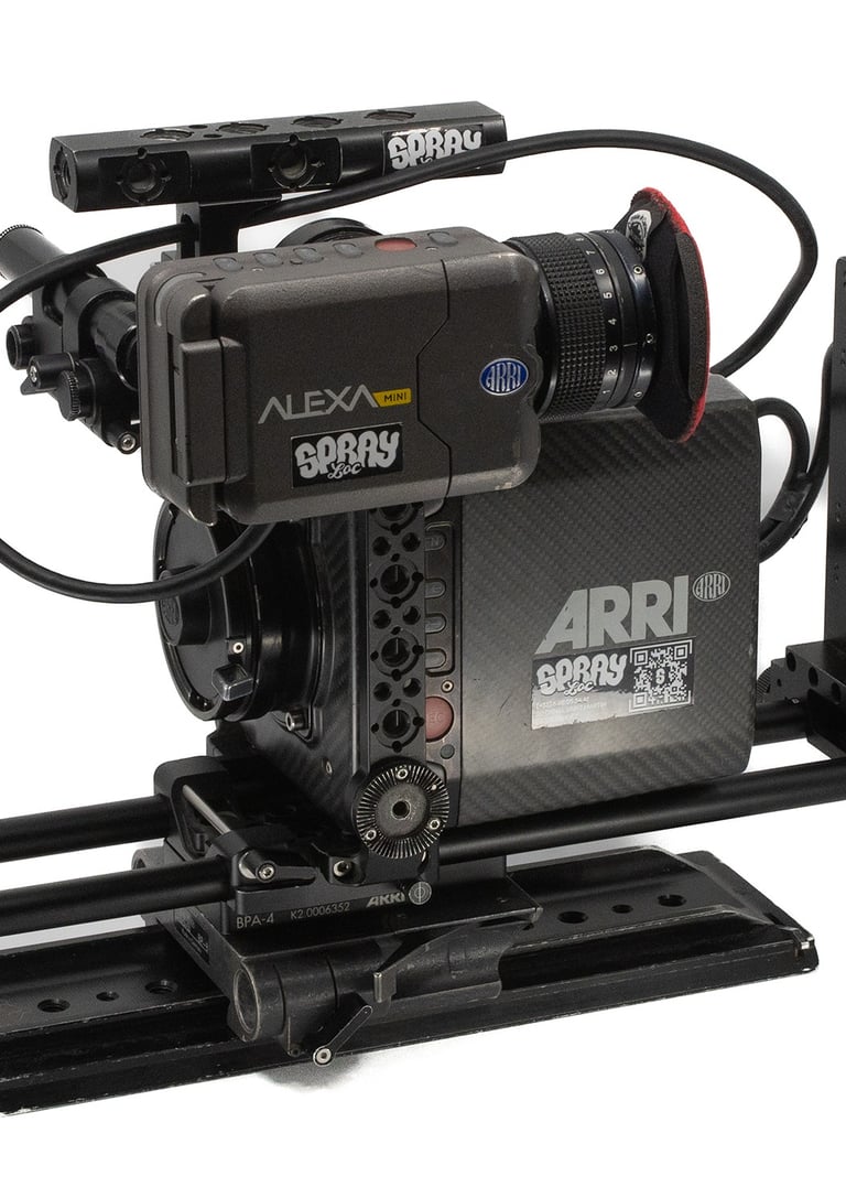 Professional ARRI Alexa Mini cinema camera rig with lens, mounting rails, and view finder on a white background.