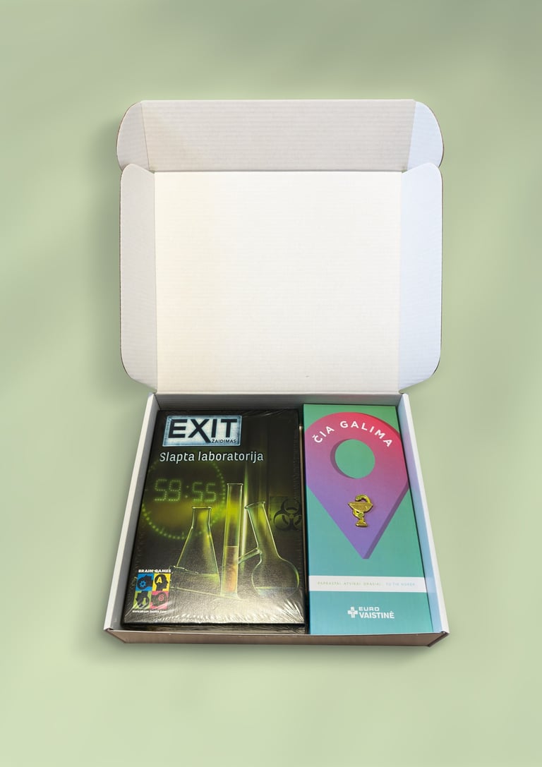 An open cardboard box containing an EXIT board game and a branded Euro Vaistine gift set.