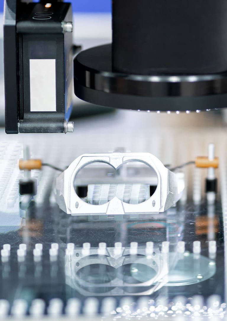 Optical CMM inspecting a fixtured component using vision and laser distance sensors.