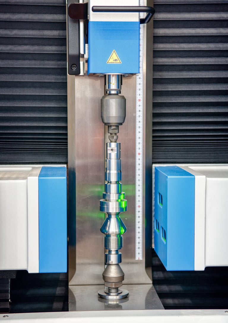 Shaft scanner inspecting a precision shaft using collimated monochromatic light.