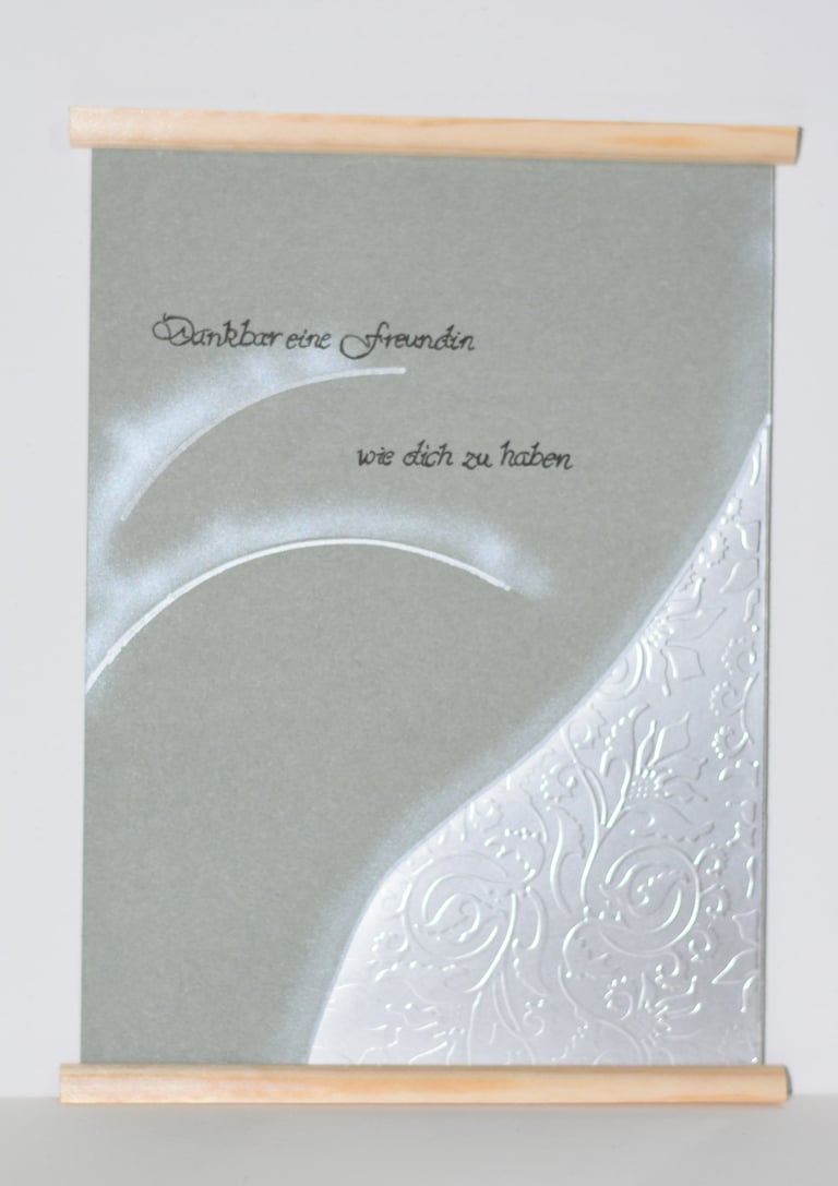 a greeting card with a white background and a silver foiled card