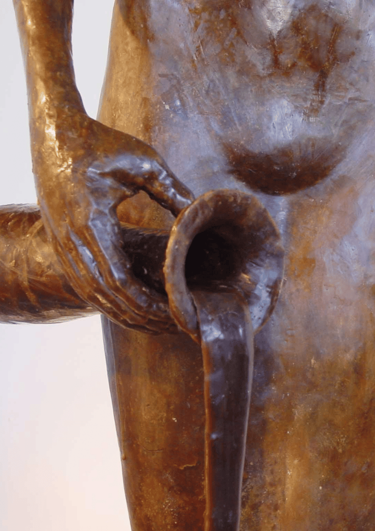 detail of carafe and hands of model