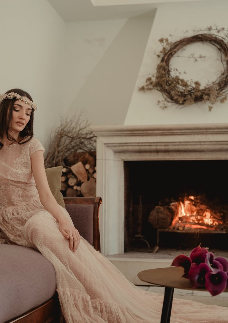 a woman in a long dress sitting on a couch