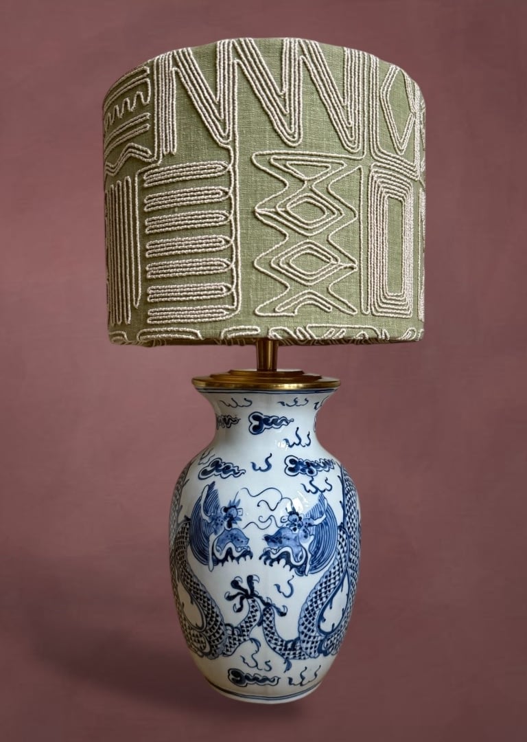 Vintage blue and white dragon porcelain table lamp with an embroidered sage green drum shade.