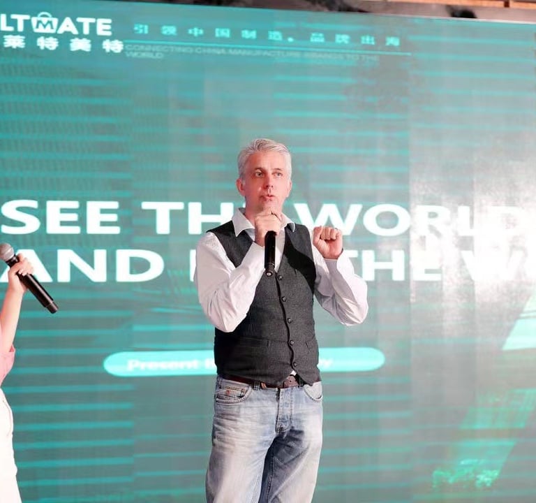 a man and woman standing in front of a large screen