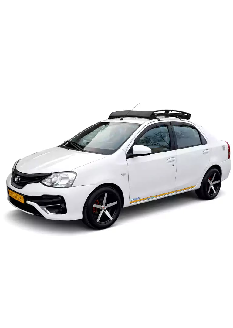 White Toyota Etios one way taxi by Saini taxi services with a luggage carrier rack