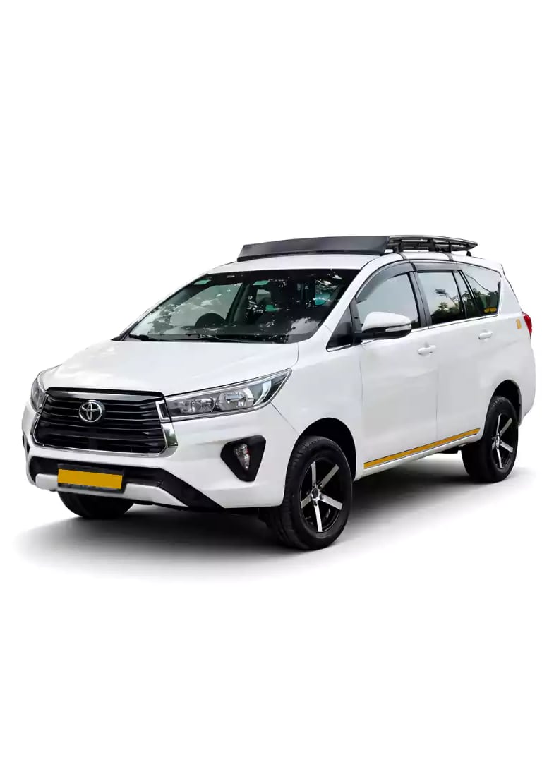 White Toyota Innova Crysta one way taxi by Saini taxi services with a luggage carrier rack