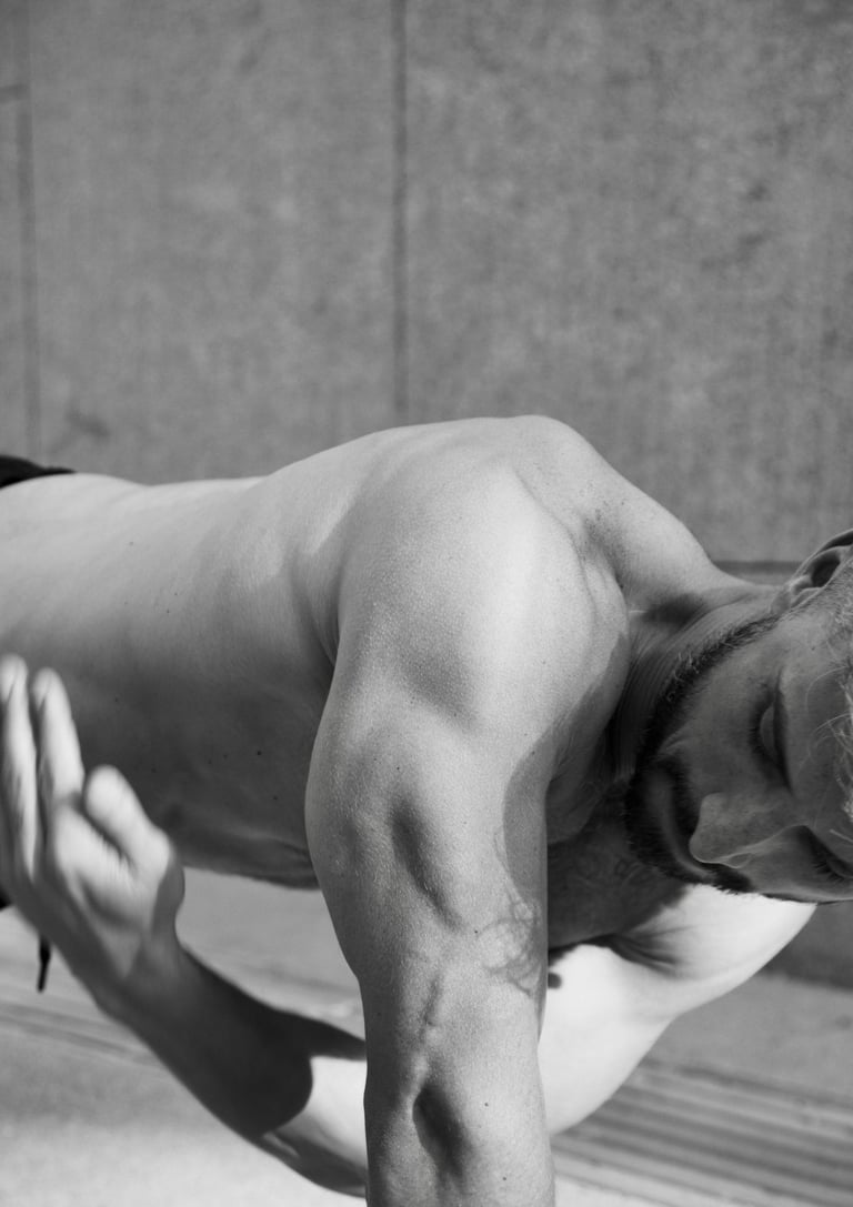 a man in a black and white photo doing rotational plank