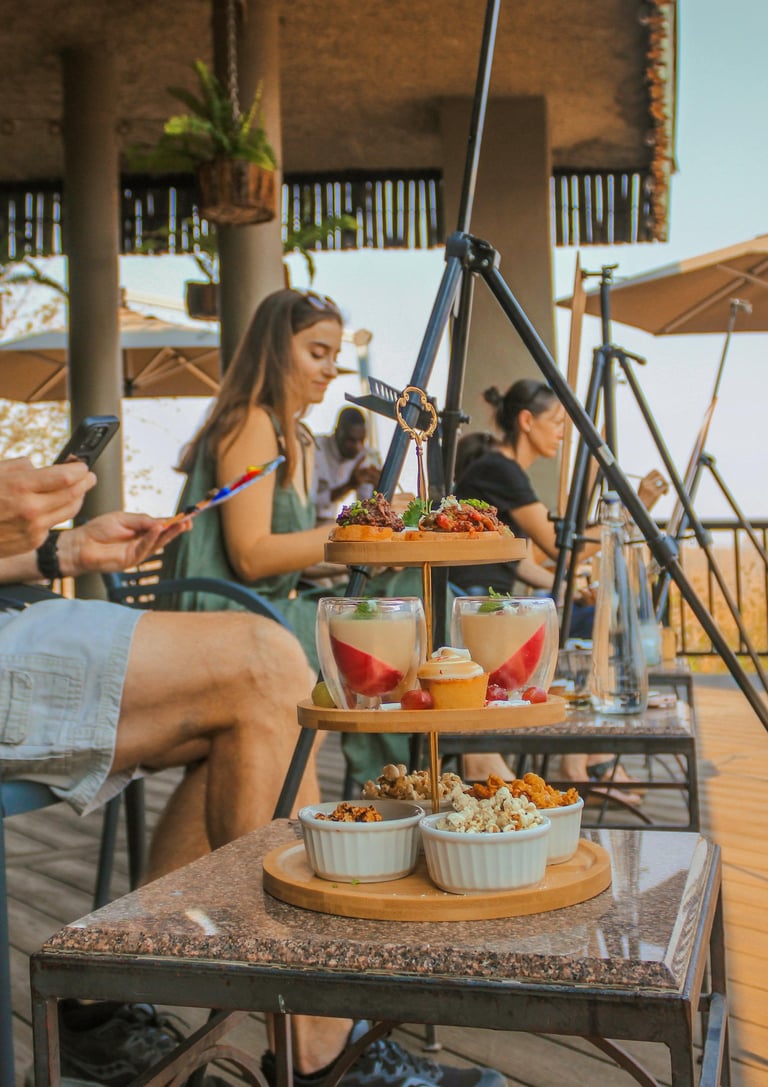 a man sitting on a table with food and drinks