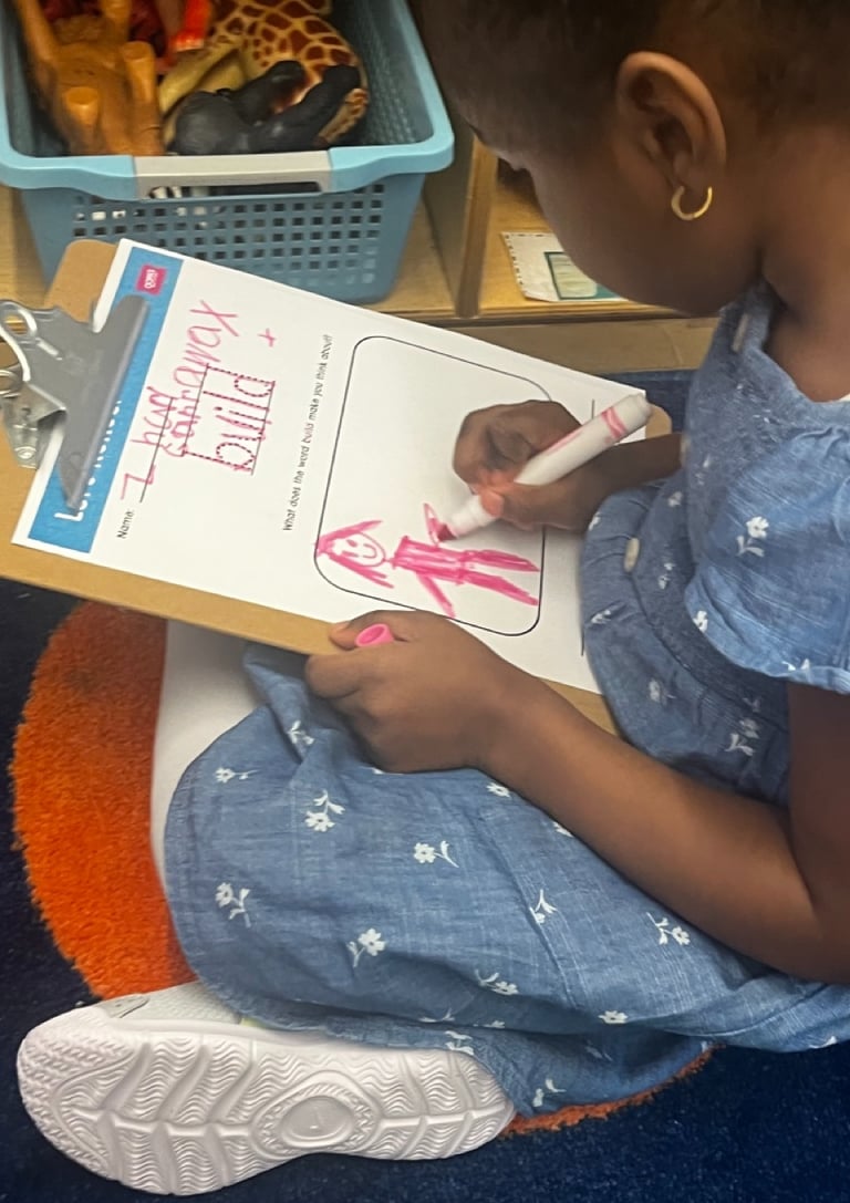 PreK students reflects on an OOPA worksheet.