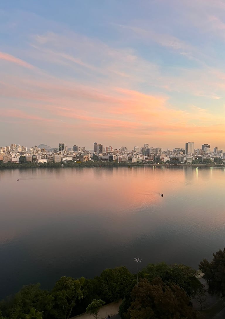 a city skyline with a river and a boat in the water