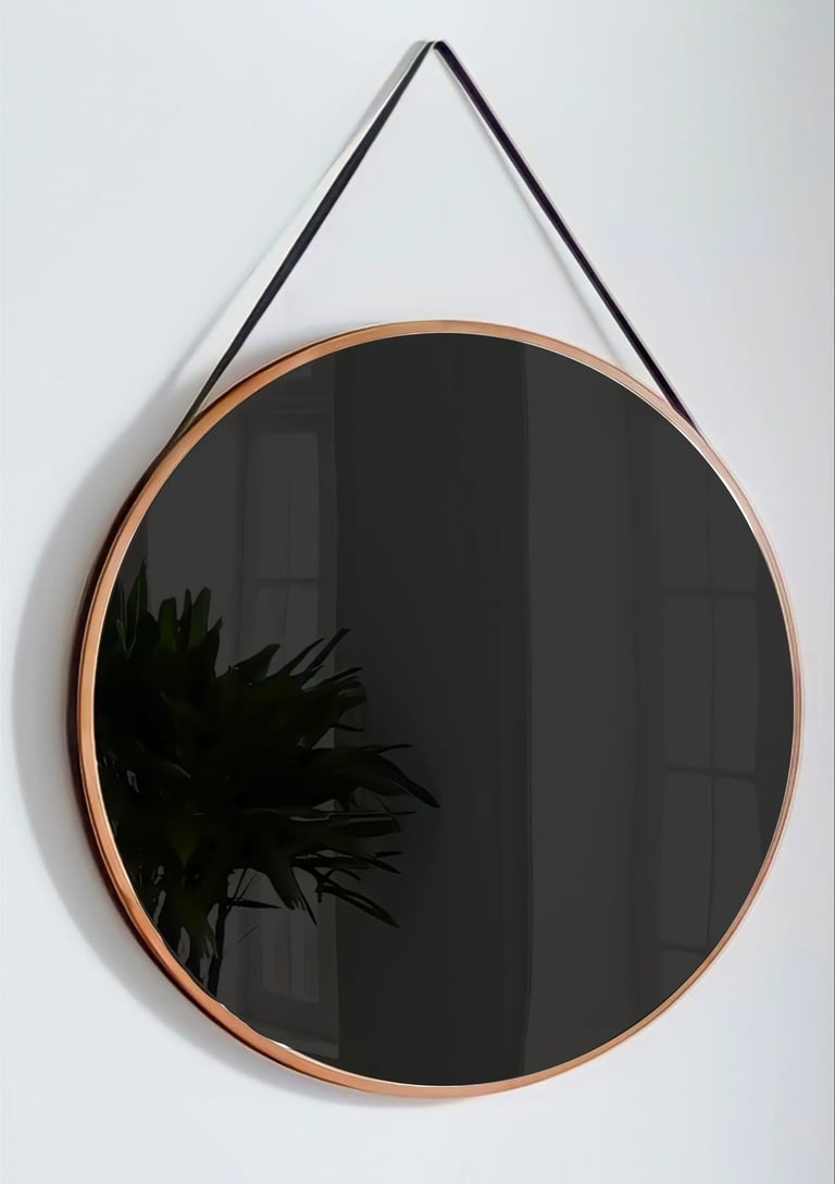 A mirror hangs on a wall with a darkened reflection, prompting the viewer to see their face
