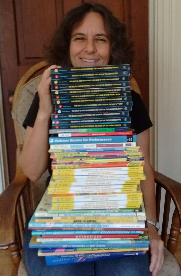 Holding tall stack of my books