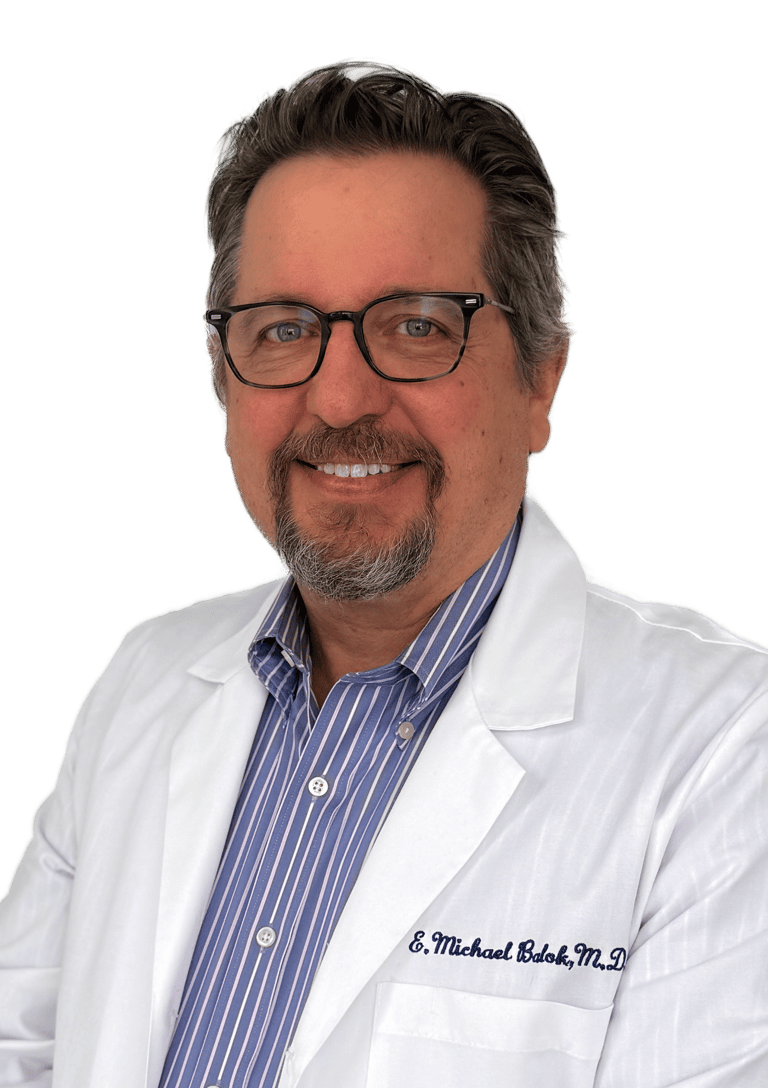 man wearing glasses in a white coat and dress shirt