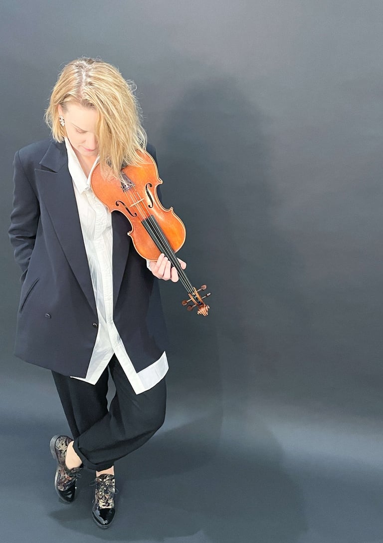 Contemporary portrait of violinist Zydre holding a violin, interdisciplinary classical music artist